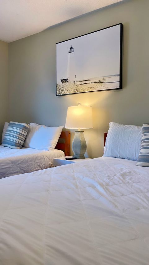 Guest Room: Bright and airy with soft lighting and coastal decor for the perfect beach retreat!