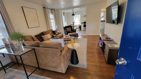 living room. L Sofa, smart TV some streaming apps available. Open floor plan