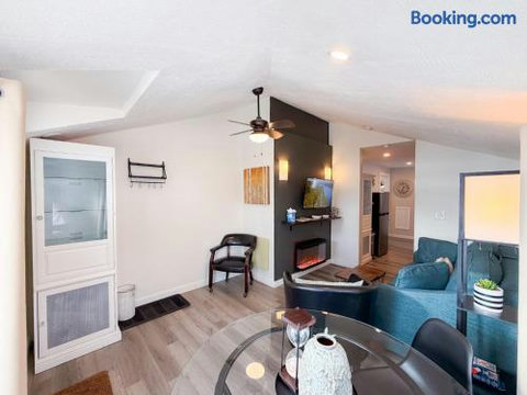 Bright modern living space with fireplace, TV, and open dining area