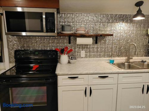 Stylish updated kitchen with full-size appliances and chic tile backsplash