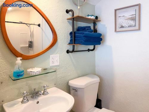 Bright guest bathroom with stylish mirror and convenient towel storage