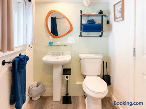 Bright bathroom with natural light, fresh towels, and stylish modern touches