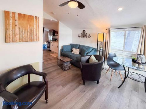 Bright open living space with dining nook, vaulted ceilings, and cozy seating