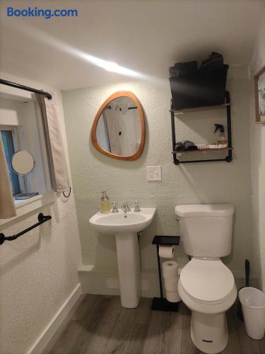 Bright, tidy bathroom with modern mirror and handy storage shelves