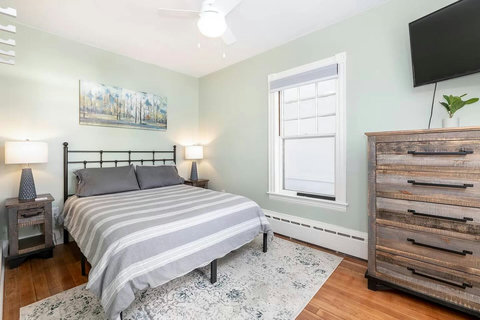 Downstairs queen bedroom with a view to the Lake, its own Roku TV, storage and wall hooks. Super quiet AC in side window during the summer to keep you cool but not keep you up!