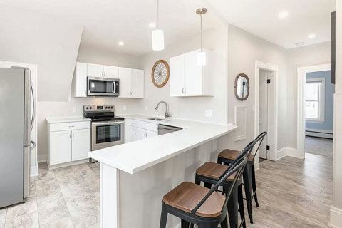 Here's the upstairs kitchen with its open seating at the bar for chatting during meal prep or for a snack.