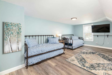 We call it the "loft". Who loves it more? The kids who get to use this as their private game and fun space, or the parents who get to have some quiet on the main floor? We don't know but we make sure its equipped with a game ready Roku TV!