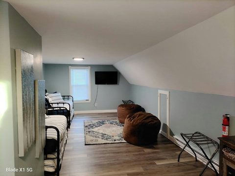 Another view showing how big this room is. 

To make it even better, we replaced the TV (pictured) with a larger Roku TV and added a shelf underneath for gaming systems or other electronics you might bring with you.