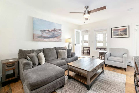 Upstairs apartment living room with super comfy furniture too! Beautiful artwork helps to set the relaxing lakeside tone. Yes, that's a sunroom with an awesome view of the Lake right off the living room!
