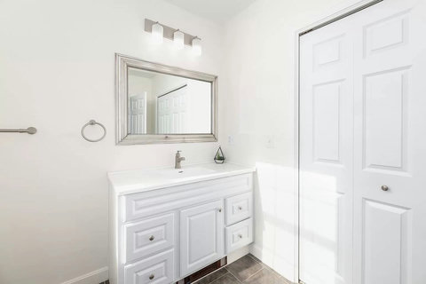 Bright full bathroom with big storage closet. Built-in supplemental heat under the sink.
