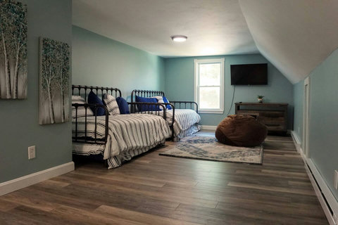 We call it the "loft". Who loves it more? The kids who get to use this as their private game and fun space, or the parents who get to have some quiet on the main floor? We don't know but we make sure its equipped with a game ready Roku TV!