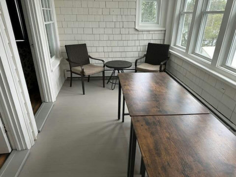 Sunporch. Tables and benches can seat 8 and can be arranged to fit your needs.