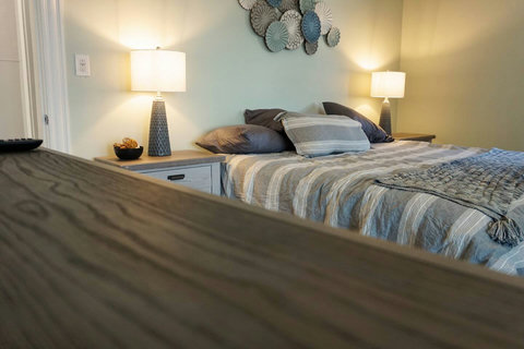 Plenty of lighting and space in this king bed with side tables with drawers.