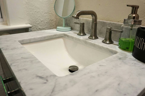 Not pictured is a full bathtub with handheld shower head. Also a full length mirror.