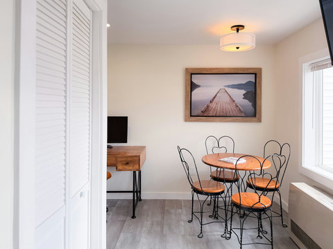 Bright dining nook with workspace, natural light, and charming decor