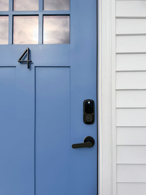 Your own private entrance — the cheerful blue door of Unit 4 welcomes you home with keyless entry and classic craftsman style.