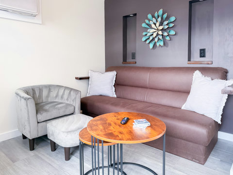 Thoughtfully designed living space — leather sofa, velvet barrel chair, and custom accent wall create an inviting place to unwind.