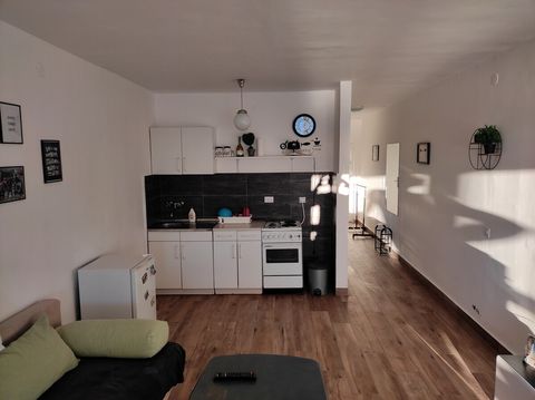 Antoher view of living room and kitchen. Hallway also