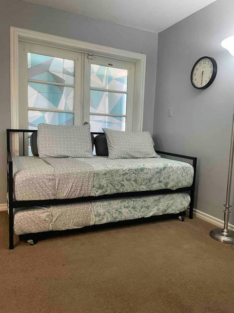 Twin bed with twin trundle underneath.
Memory foam mattress both with mattress protectors 
The door behind is locked. We don’t use that door conecta to our carport. 
Please remove shoes all the times in carpet area 
