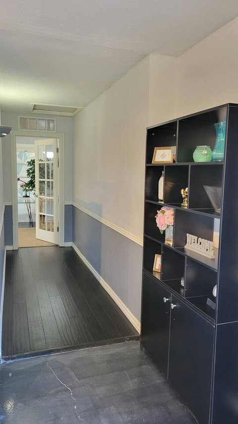Pantry shelf with decorations leading into bedroom hallway.