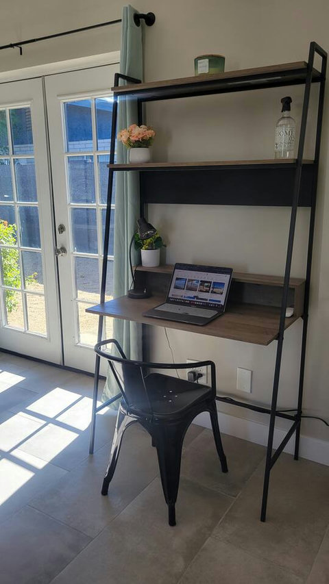 Desk workspace with plenty of natural lighting and garden view.