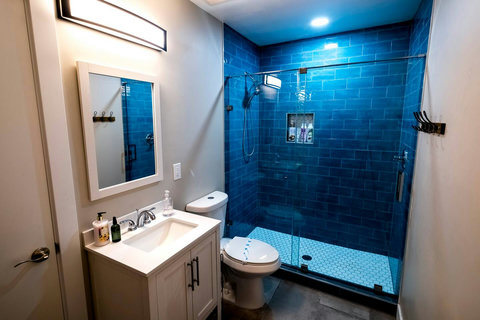 Large bathroom with walk-in shower fully sanitized and stocked with soap, body wash, shampoo and conditioner for your arrival.