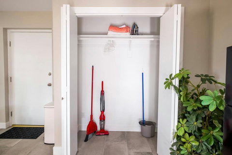 Cleaning supplies stocked under sink, include mop bucket, vacuum, broom and dust pan.  Extra linens, iron and hangars in the large closet.