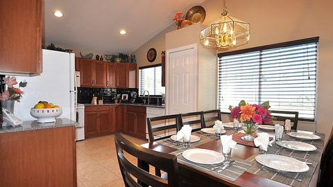 A chef's kitchen with maple cabinets, quartz countertop, and tile backsplash provide an enjoyable space to whip up a quick meal, or a total feast!