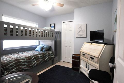 The middle bedroom features twin bunks and a desk.