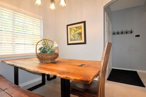 The dining area has room for your entire party, on a unique Acacia wood table.