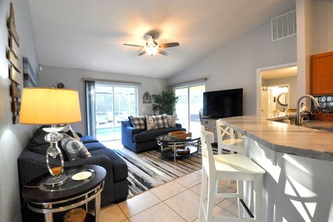 The living room/lounge area with the pool deck just steps away.