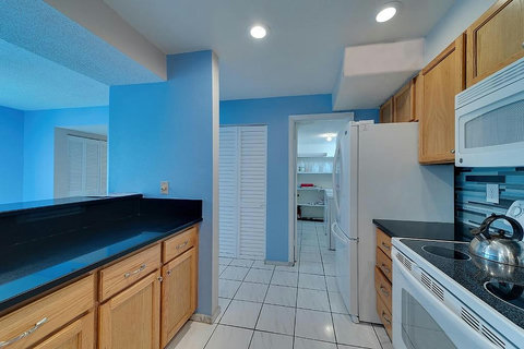 Kitchen with attached private laundry room
