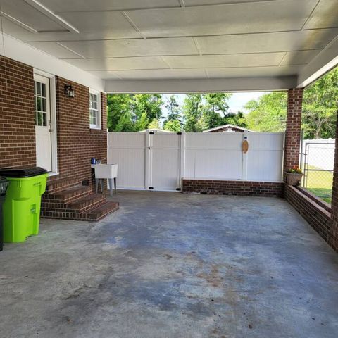 Carport with tiki toss game