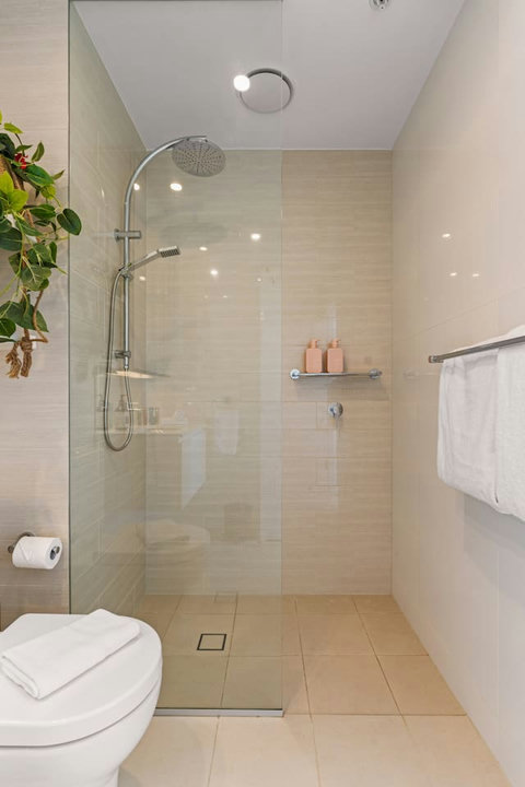 Enjoy a spacious glass-enclosed shower designed with comfort and style in mind.
