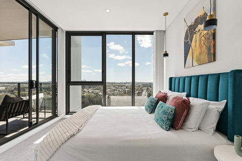 Enjoy direct balcony access and panoramic outlooks from this luxurious light-filled master retreat.