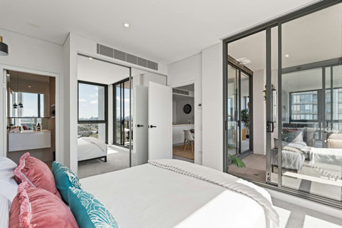 The spacious master suite combines stunning views, balcony access, and contemporary comfort for an unforgettable stay.