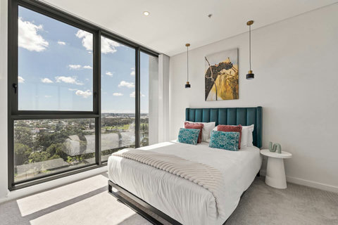 Wake up to breathtaking skyline and river views from the comfort of the beautifully appointed master bedroom.