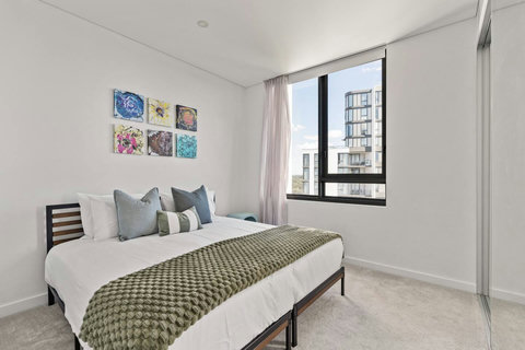Retreat to a peaceful bedroom featuring a comfortable queen bed and abundant natural light.