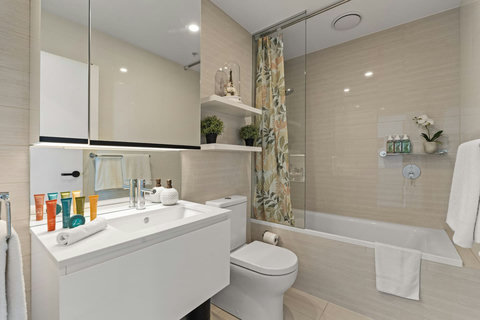 The beautifully appointed bathroom offers a full-size bathtub, quality amenities, and ample space.