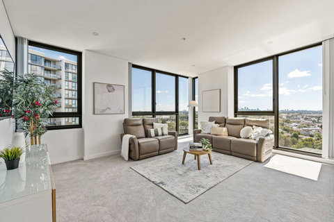 Floor-to-ceiling windows showcase stunning views while filling the living space with natural light.