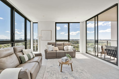 Relax in a light-filled living space framed by sweeping district views and expansive windows in every direction.