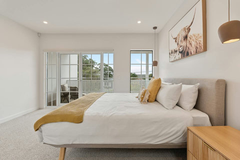 Wake up to natural light in the spacious master retreat with private balcony access.