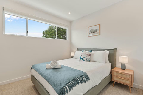 Thoughtfully styled with quality bedding and coastal-inspired touches throughout.