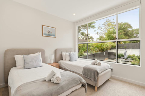 Thoughtfully styled with quality bedding and coastal-inspired touches throughout.