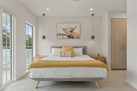 Wake up to natural light in the spacious master retreat with private balcony access.