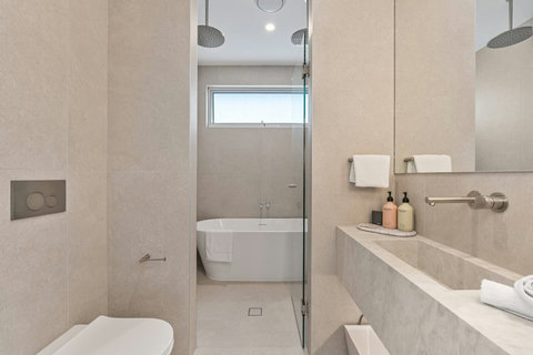 Stylish family bathroom featuring a bathtub, walk-in shower and premium finishes.