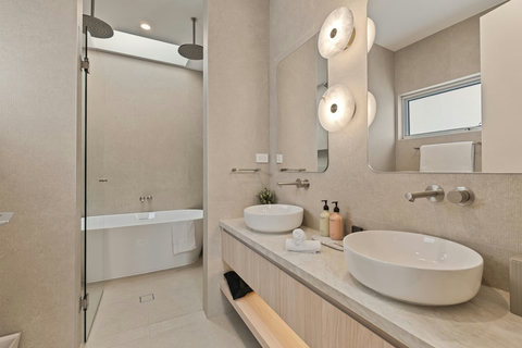 Stylish family bathroom featuring a bathtub, walk-in shower and premium finishes.