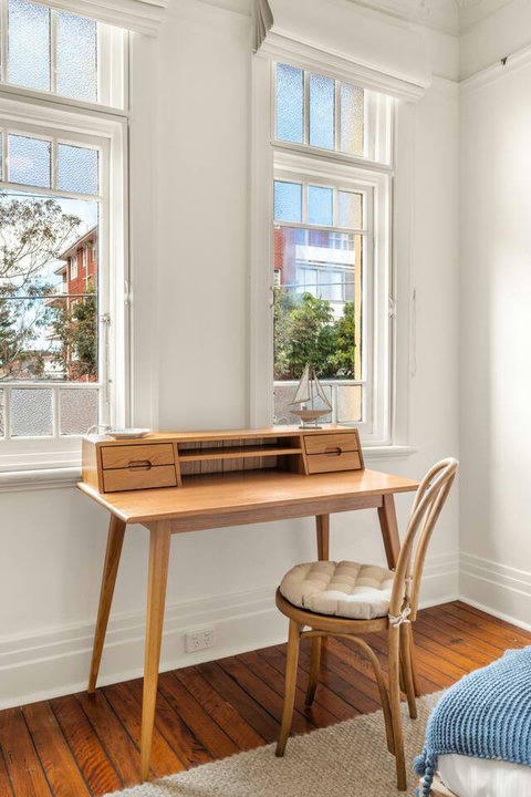 Dedicated Workspace | A desk beside the window provides a practical setup for work or study