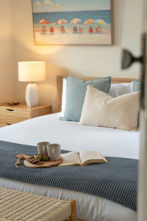 Thoughtful bedside details and soft textures create a welcoming place to recharge