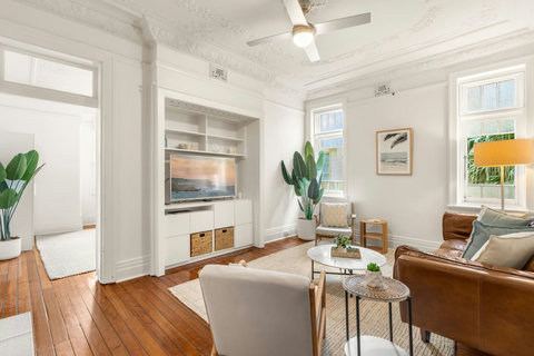Warm timber floors and soft coastal tones create a relaxed setting for time together